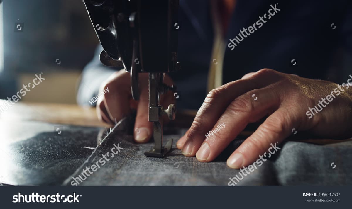 Experienced tailor sewing high-quality apparel